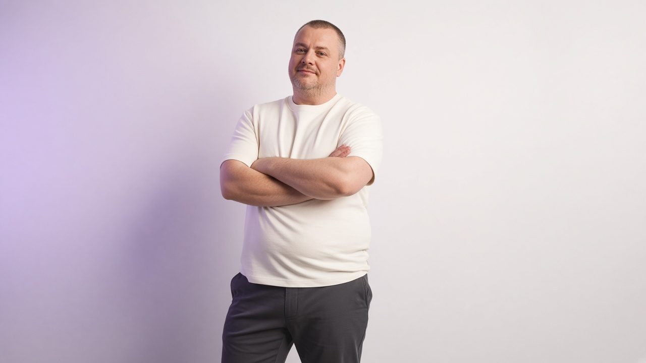 Man in an off-white tee and charcoal chinos